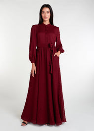 This Crinkled Chiffon Maxi Burgundy is fully lined, lightweight, and airy. It also has the option of a belt and pockets for added convenience. The chiffon material adds texture.