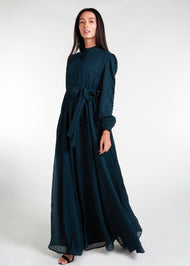 This Crinkled Chiffon Maxi Green is fully lined, lightweight, and airy. It also has the option of a belt and pockets for added convenience. The chiffon material adds texture.