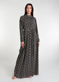 This maxi dress boasts a raised mandarin neck line with subtle pleats, as well as the option to cinch it in at the waist. It also features discreet side pockets and is made from a lightweight, airy fabric. Base colour is black with ditsy small cream daisy print all over. 