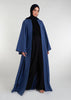 Waist pleats create a flowy silhouette, accompanied by wide sleeves and a stylish kimono style. The denim blue color adds to its overall appeal, while pockets provide functionality.