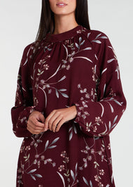 This floral maxi dress in maroon boasts a raised mandarin neck line and subtle pleating for a sophisticated touch. The flowing silhouette can be cinched at the waist, and discreet side pockets offer practicality. Made from lightweight, airy fabric for a comfortable fit.