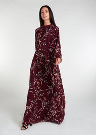 This floral maxi dress in maroon boasts a raised mandarin neck line and subtle pleating for a sophisticated touch. The flowing silhouette can be cinched at the waist, and discreet side pockets offer practicality. Made from lightweight, airy fabric for a comfortable fit.