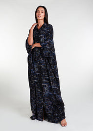 Designed with a modest, loose-fitting silhouette, this shirted kaftan is ideal for your summer wardrobe and holiday attire. The garment features buttons all the way down and is even suitable for nursing. You can also style it with your own belt to cinch in at the waist. Colour is dark navy blue with graphic abstract print of lines.