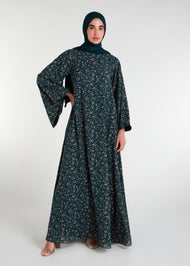 The Kew Maxi Dress is a lightweight and flowy maxi dress, complete with bell sleeves. Its vibrant green color and delicate floral print make it the perfect choice for a breezy summer day. 