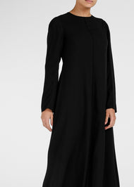 Cut in an A line silhouette with a round neck collar & semi fitted sleeves. Features a concealed zip fastening at the back for easy access. Black