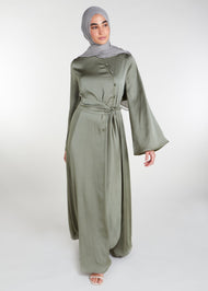 Crafted from a light weight silk-like fabric with a subtle sheen, this abaya features a fitted oriental style bodice and self fabric buttons, flaring from the waist. Olive Green colour.