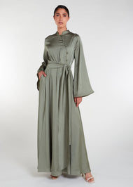 Crafted from a light weight silk-like fabric with a subtle sheen, this abaya features a fitted oriental style bodice and self fabric buttons, flaring from the waist. Olive Green colour.