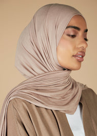 Effortless to style and incredibly comfortable to wear, with a subtle sheen. The medium-thick weight is soft, breathable, fully opaque and durable. Jersey works well in all climates, can be worn without an under scarf or pins, and makes a great option for working out. Light nude pink.