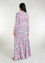 Featuring a vibrant floral pattern with an optional belt for styling, standard collars, discreet side pockets, and buttons all the way down, this maxi dress is perfect for any occasion. It is also suitable for nursing, making it a practical and stylish choice for any mother. Light blue base colour with pink roses and  green thorns and leaves.