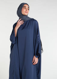  Satin Strip Kaftan in a deep blue hue features a luxurious satin strip detailing on the neckline and sleeves, creating a modest and sophisticated silhouette. Perfect for any occasion, this kaftan exudes a sense of luxury and style.
