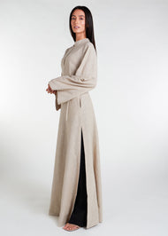 The Side Tie Maxi Natural offers a sleek and stylish look with its mandarin neck line, concealed buttons, and high side slits. Its slim fit silhouette and looser fitting sleeves provide both comfort and sophistication. Nude grey colour.