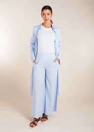 The Sky Blue Co-Ord Set features a light cotton feel and includes loose fit flared trousers paired with a long shirt. This versatile set allows for both open and closed styling, making it the perfect outfit for summer. To ensure a seamless look, we recommend wearing nude undergarments or a vest underneath, as light cotton fabrics tend to be sheer.