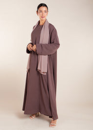 This elegant Two Piece Open Abaya set includes a Full Sleeve matching inner dress. Perfect for everyday wear, it can also be dressed up with accessories for an evening look. The open abaya can be worn as a maxi on its own or paired with the inner dress for a stylish ensemble. In brown.