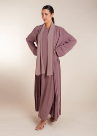 This elegant Two Piece Open Abaya set includes a Full Sleeve matching inner dress. Perfect for everyday wear, it can also be dressed up with accessories for an evening look. The open abaya can be worn as a maxi on its own or paired with the inner dress for a stylish ensemble. In purple.